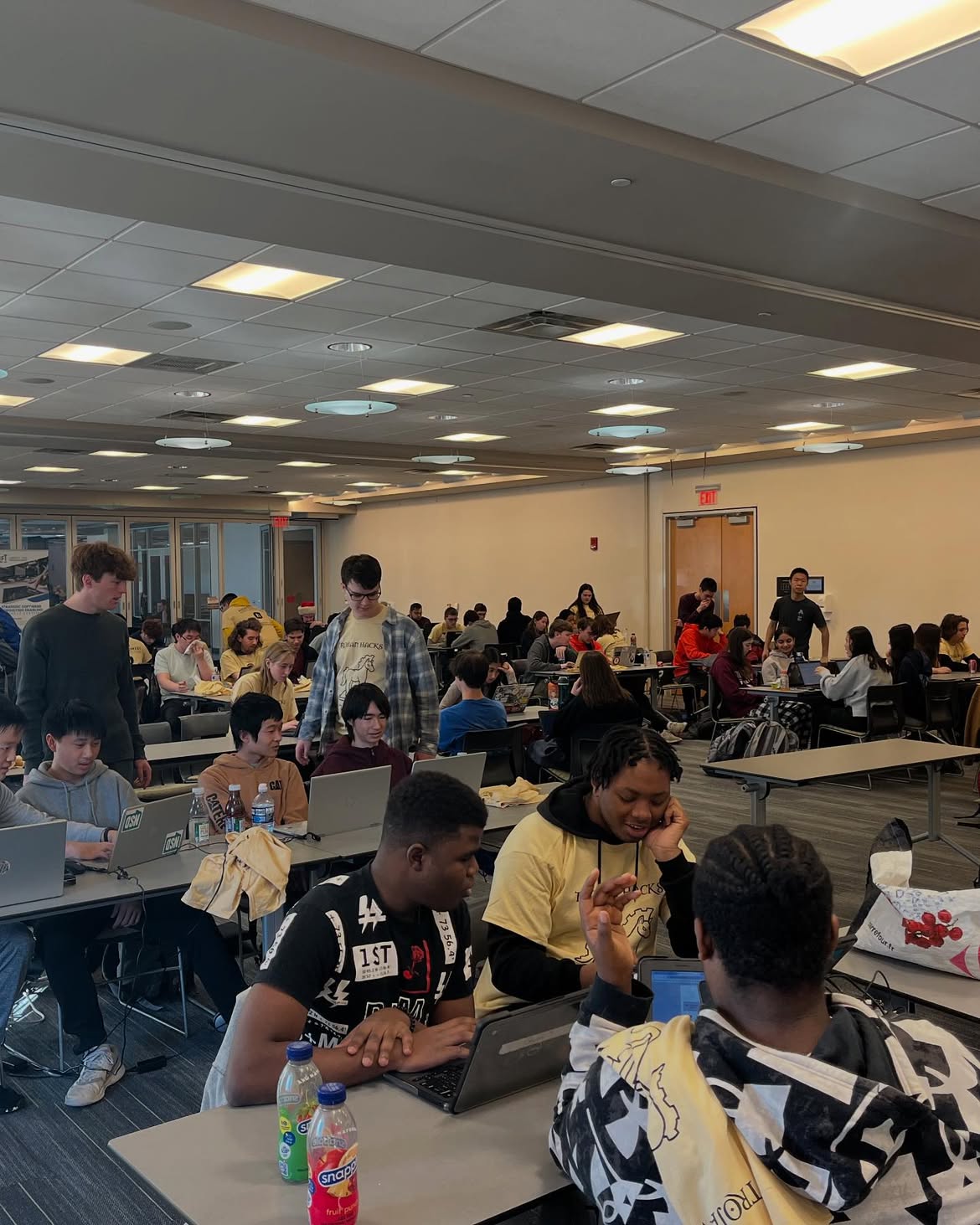Students coding at Trojan Hacks